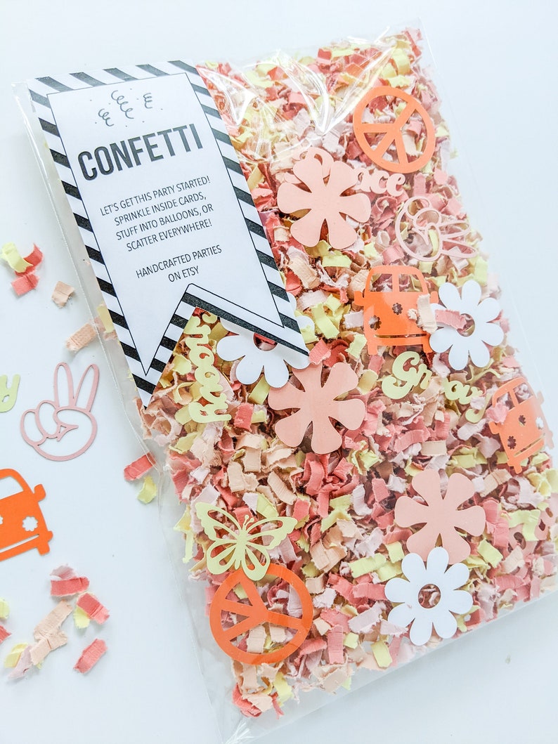 May include: A clear plastic bag filled with confetti. The confetti is made of paper and features peace signs, flowers, butterflies, and the word "groovy". The bag also includes a tag that reads "Confetti Let's get this party started! Sprinkle inside cards, stuff into balloons, or scatter everywhere! Handcrafted parties on Etsy."