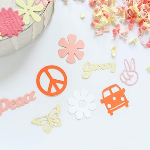 May include: A collection of paper cutouts in various shapes and colors, including peace signs, flowers, butterflies, and a van. The words "Peace" and "Groovy" are also included.
