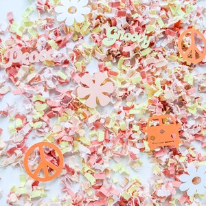 May include: A collection of colorful confetti with peace signs, flowers, and the words "Peace" and "Groovy" on a white background.