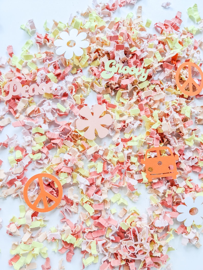 May include: A collection of colorful confetti with peace signs, flowers, and the words "Peace" and "Groovy" on a white background.