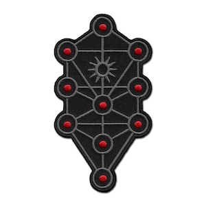 May include: Embroidered black patch featuring a geometric design with interconnected circles and lines. The circles are accented with red centers, and a sun-like symbol is in the center. The patch has a dark gray border.