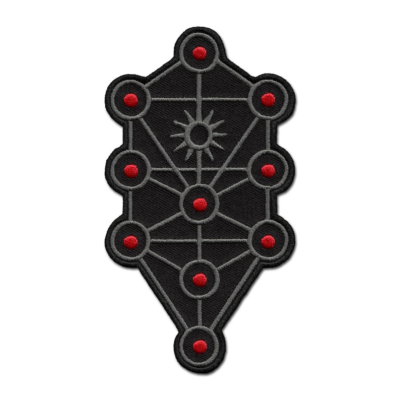 May include: Embroidered black patch featuring a geometric design with interconnected circles and lines. The circles are accented with red centers, and a sun-like symbol is in the center. The patch has a dark gray border.