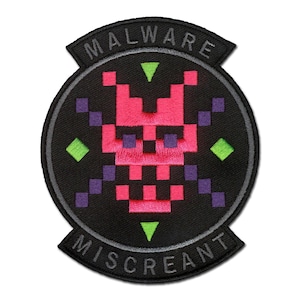 May include: A circular embroidered patch with a black background featuring a pixelated pink skull design in the center. The patch includes purple pixelated crossbones, green diamond accents, and the text MALWARE MISCREANT in white lettering.