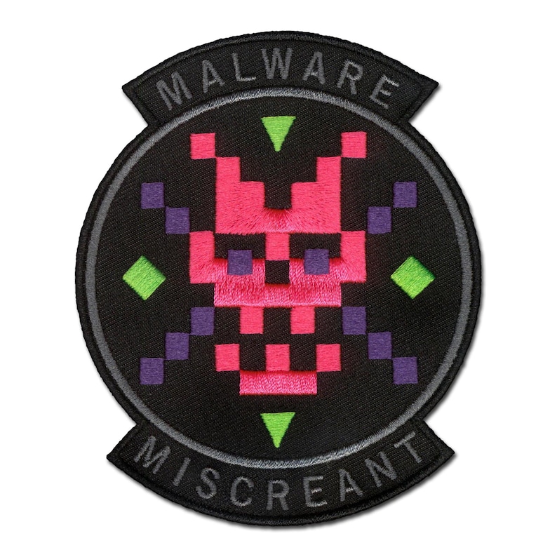 May include: A circular embroidered patch with a black background featuring a pixelated pink skull design in the centre. The patch includes purple pixelated crossbones, green diamond accents, and the text MALWARE MISCREANT in white lettering.