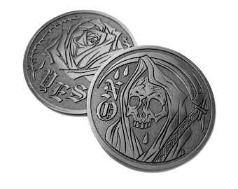 May include: Two circular metal coins with a dark finish. One coin features an embossed rose and the word YES in gothic lettering. The other coin displays a hooded skull figure holding a scythe with the word NO embossed in gothic lettering.