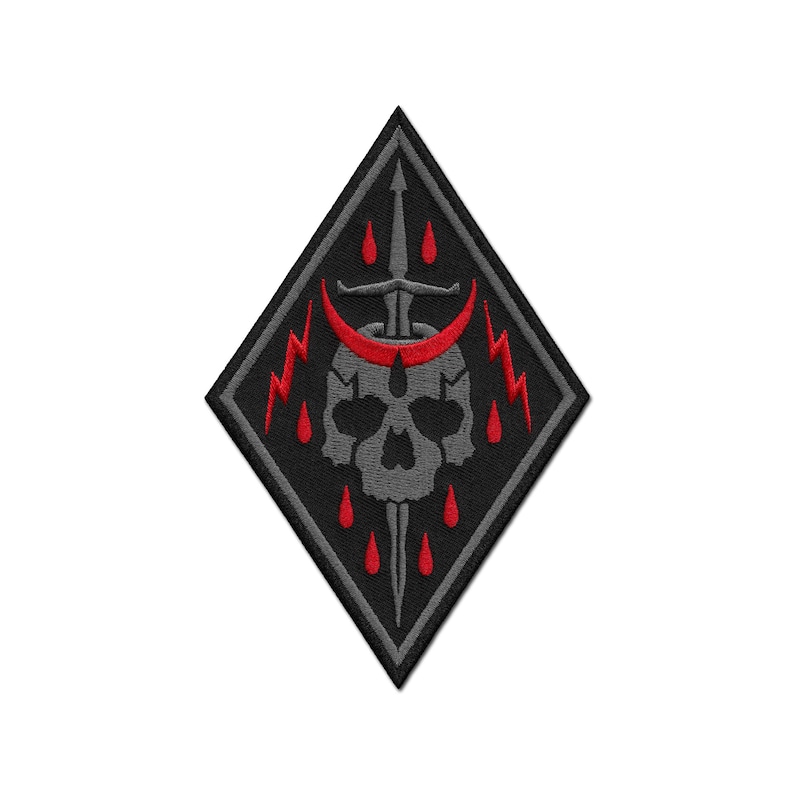 May include: A diamond-shaped embroidered patch featuring a grey skull centered behind a vertical sword. A red crescent moon sits above the skull, flanked by red lightning bolts. Red teardrop shapes are arranged around the sword and skull.