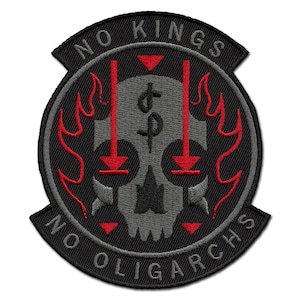 May include: Embroidered patch with a black background and a central design featuring a gray skull. Red flames and arrows surround the skull. The text "NO KINGS" arches across the top, and "NO OLIGARCHS" curves along the bottom.