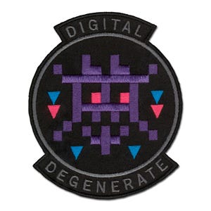 May include: A circular embroidered patch with a black background featuring a purple pixelated creature design. The patch includes the text DIGITAL at the top and DEGENERATE at the bottom in gray lettering, with small blue and pink triangle accents.