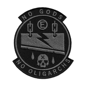 May include: Black and gray embroidered patch with the text "No Gods No Oligarchs" and a skull with a lightning bolt and two bolts on either side.