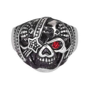 May include: A silver ring featuring a black skull design with a red gemstone eye. The skull is intricately carved and has a bandaged eye.