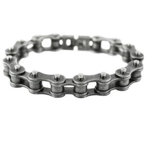 May include: A silver-toned chain bracelet made of linked metal pieces. The bracelet is designed to look like a bicycle chain.
