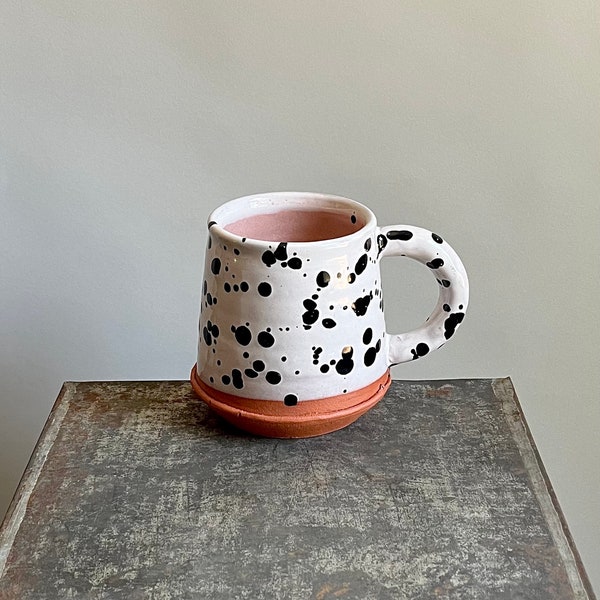 black speckle mug with pastel pink interior, handmade pottery with coil handle