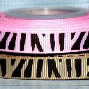 May include: Two rolls of ribbon with a zebra print pattern. The top roll is pink with black stripes and the bottom roll is brown with black stripes.