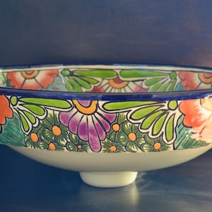 A Oval sink that goes on top of the cabinet