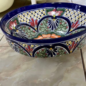 A round sink that goes on top of the cabinet