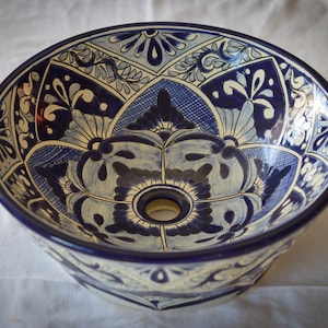 A round sink that goes on top of the cabinet