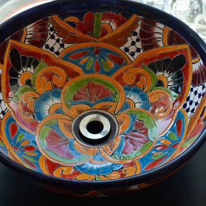 A round sink that goes on top of the cabinet