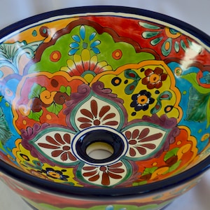 A round sink that goes on top of the cabinet