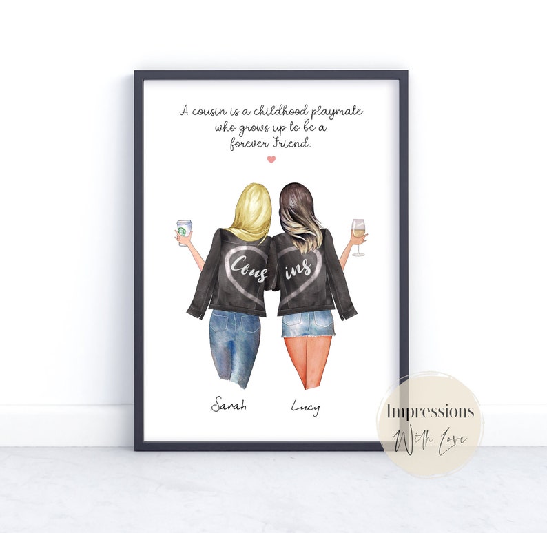 May include: A framed illustration of two women wearing black jackets with the words "Cous" and "ins" on the back. The women are holding a coffee cup and a glass of wine. The text below the image reads "A cousin is a childhood playmate who grows up to be a forever friend." The names "Sarah" and "Lucy" are written below the women. The bottom right corner of the image has the text "Impressions With Love."