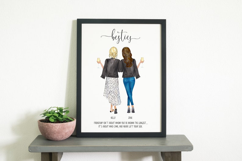 May include: A framed print with an illustration of two women wearing black jackets and holding glasses of wine. The text "besties" is at the top of the print. The text "Friendship isn't about whom you've known the longest - it's about who came, and never left your side" is at the bottom of the print.