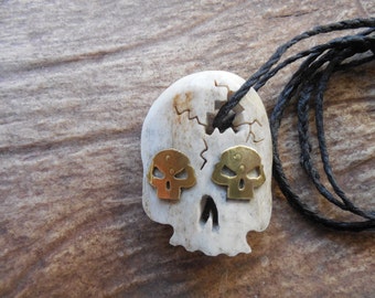 large skull necklace with brass skulls for eyes