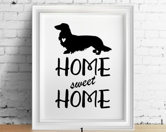 May include: Black and white print of a dachshund with a heart on its chest. The text "Home sweet Home" is below the dog.