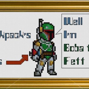 Op de afbeelding: Een kruissteekontwerp met een gepixelde afbeelding van Boba Fett uit Star Wars. De tekst "My backpack's got jets" staat aan de linkerkant van de afbeelding, en "Well I'm Boba Fett" staat aan de rechterkant van de afbeelding.