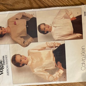 May include: A sewing pattern for a blouse by Calvin Klein. The pattern is from Vogue Patterns, American Designer. The pattern number is 1230.