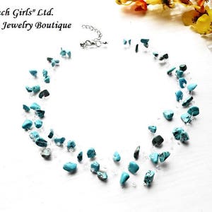 May include: Turquoise gemstone necklace with a silver chain. The necklace is made of small, irregular turquoise stones and silver beads.