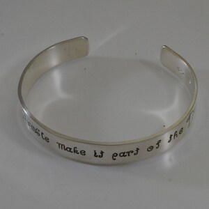 May include: Silver bangle bracelet with the inscription "Sometimes make it part of the"