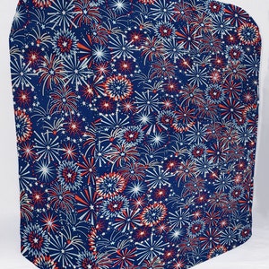 May include: A blue fabric cover with a red, white, and blue fireworks pattern. The cover is made of a soft, durable fabric and is perfect for protecting furniture or other items.