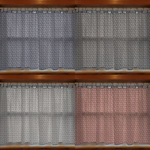 May include: Four sets of patterned curtains in different colors: navy blue, gray, light gray, and coral. Each curtain has a repeating geometric design and is hung on a rod with decorative rings. The curtains are displayed in a window setting.