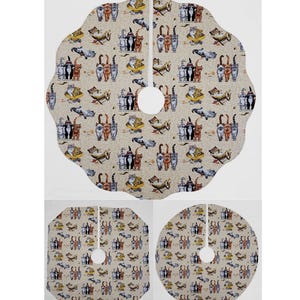 May include: A beige and brown patterned Christmas tree skirt with a variety of cats wearing witch hats and holding brooms. The skirt has a scalloped edge and a hole in the center for the tree trunk.