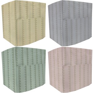 May include: Four square storage boxes with a patterned design. The boxes are in yellow, gray, green, and pink.