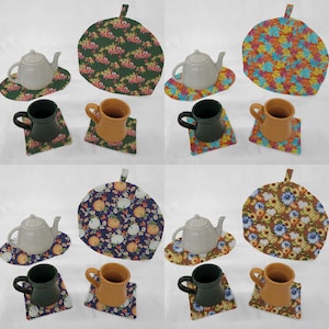 May include: Four sets of tea cozies and teacups with matching coasters. The cozies are round and feature different autumn-themed patterns: pumpkins, fall leaves, and floral designs. The teacups are white with a brown handle and the coasters are square with a variety of patterns.