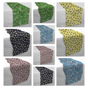 May include: Nine table runners in various colors, each featuring a repeating bird pattern. Colors include green, yellow, blue, pink, and navy. The runners are displayed on a white surface, showcasing the different color options.