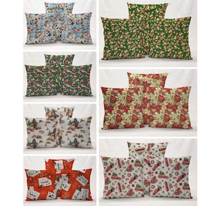 May include: Set of three Christmas-themed throw pillows with various patterns. The pillows feature red, green, and white colors with images of Santa Claus, reindeer, and Christmas trees.