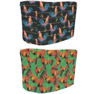 May include: Two fabric bands with a rooster pattern. The top band is black with red, yellow, and blue roosters. The bottom band is green with orange roosters.