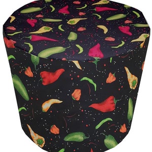 May include: Black chef hat with a repeating pattern of red, yellow, and green chili peppers on a black background.