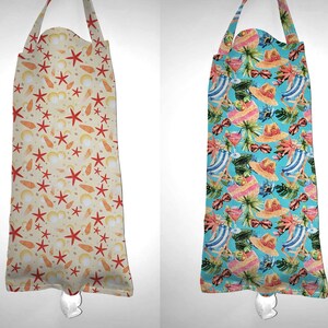 May include: Two reusable grocery bags with different summery patterns. The bag on the left has a beige background with red starfish and yellow seashells. The bag on the right has a blue background with tropical leaves, pink cocktails, and blue and white striped beach chairs.