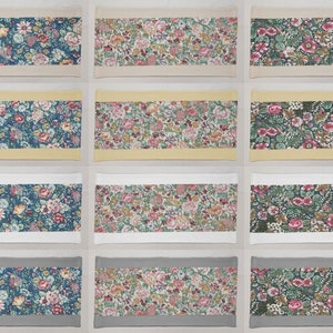 May include: Nine fabric samples with floral patterns. The samples are arranged in three rows of three. The top row has a beige background, the middle row has a yellow background, and the bottom row has a gray background. The floral patterns are in shades of blue, green, pink, and yellow.
