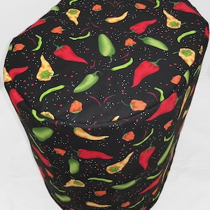 May include: Black fabric kitchen appliance cover with a repeating pattern of red, green, and yellow chili peppers on a black background with white dots.