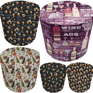 May include: Four different designs of fabric covers for a wine or beer bottle. The designs feature a variety of wine and beer related images and text, including grapes, bottles, glasses, and the words "Wine Age" and "Just like wine, I get better with age".