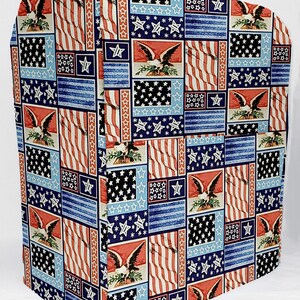May include: A red, white, and blue fabric cover with a patchwork design of American flags and bald eagles. The cover is made of a soft, durable fabric and is perfect for protecting your appliances.