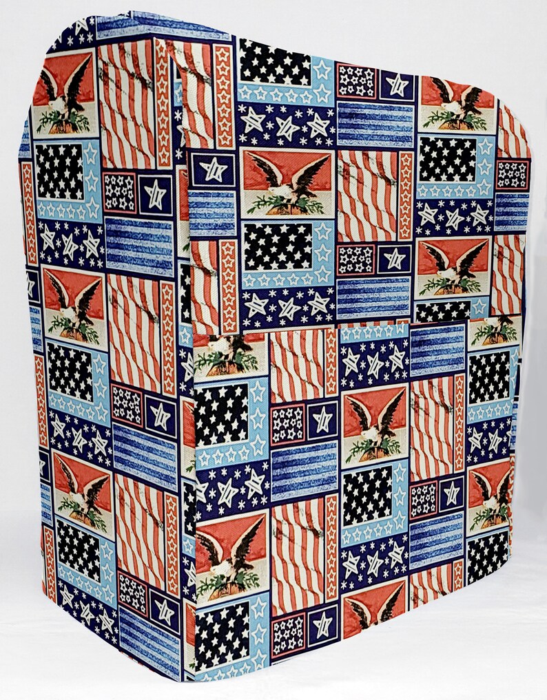 May include: A red, white, and blue fabric cover with a patchwork design of American flags and bald eagles. The cover is made of a soft, durable fabric and is perfect for protecting your appliances.