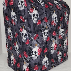 May include: A black and gray kitchen appliance cover with a skull and rose pattern. The cover features white skulls with red roses and a spiderweb design.