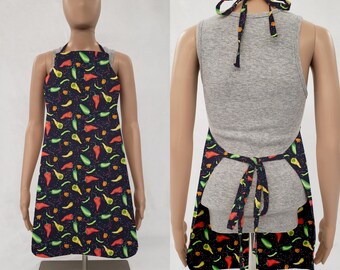 May include: A black apron with a colorful chili pepper pattern. The apron has adjustable straps and a pocket.
