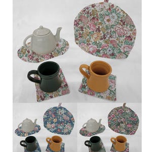 May include: Set of four floral tea cozy and coaster sets. The tea cozy is a half-circle shape with a floral pattern. The coasters are square with a floral pattern. The set includes a teapot, two mugs, and a teacup.