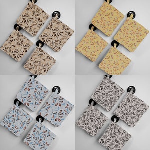 May include: Set of six fabric squares with a variety of floral patterns. The squares are in shades of brown, yellow, blue, and gray. Each square has a different pattern, but all have a similar floral design.