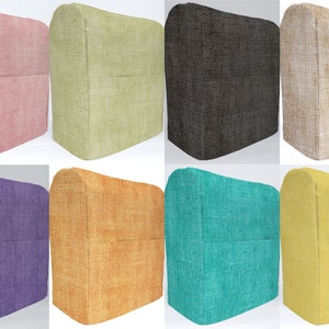 May include: Eight different colored fabric covers for a kitchen appliance. The covers are made of a textured fabric and have a pocket on the front. The colors are pink, green, gray, beige, purple, orange, teal, and yellow.